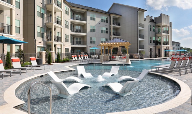 Swimming Pool Large sparkling blue pool with a large deck and lounge chairs