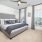 carpeted bedroom with large windows