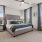 ceiling fan and light fixture in bedroom with large windows